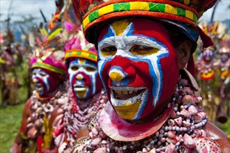 Members of a tribe in colourfully decorated costumes with face paint at the traditional sing-sing gathering