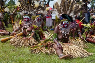 Women in colourfully decorated costumes with face paint at the traditional sing-sing gathering