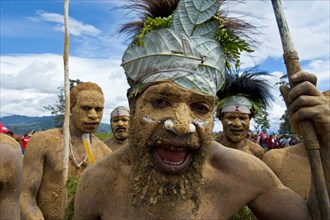 Members of a tribe in colourfully decorated costumes with face and body paint at the traditional sing-sing gathering