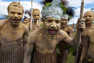 Members of a tribe in colourfully decorated costumes with face and body paint at the traditional sing-sing gathering