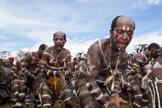 Members of a tribe with face and body paint at the traditional sing-sing gathering