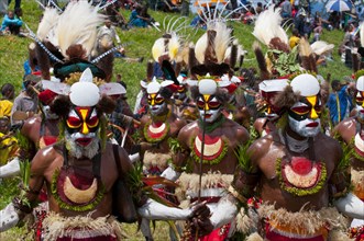 Members of a tribe in colourfully decorated costumes with face paint at the traditional sing-sing gathering