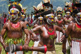 Members of a tribe in colourfully decorated costumes with face paint at the traditional sing-sing gathering