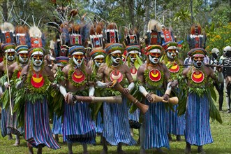 Men in colourfully decorated costumes with face paint are celebrating at the traditional Sing Sing gathering in the highlands