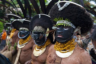 Black decorated and painted tribesmen celebrating the traditional Sing Sing in the highlands