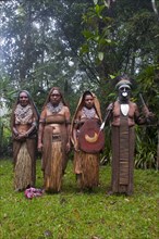Tribal chief and three women wearing traditional dresses