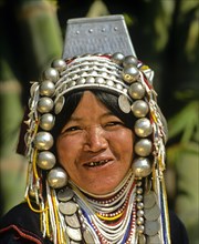 Woman from the people of the Akha wearing traditional costume with a headdress