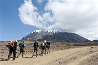 Group of hikers on a path at the Kibo saddle