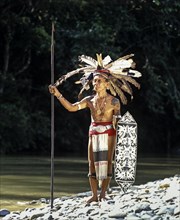 Head hunter of the ethnic group of the Iban people with a spear