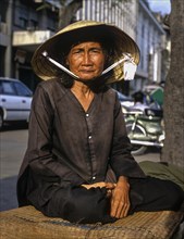 Elderly Vietnamese woman with a conical hat or Non La