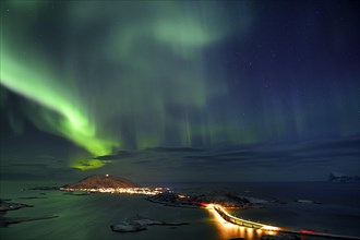 Fjord with islands in winter and the northern lights