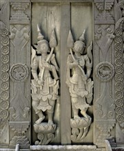 Carved figures on a teak wood door