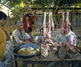 Woman selling meat at a market