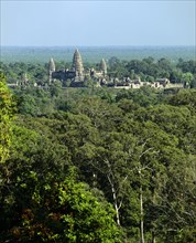 View from Phnom Bakheng towards Khmer Temple with its towers rising out of the jungle