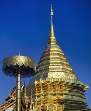 Wat Phra That Doi Suthep mountain temple with golden chedi with a golden umbrella