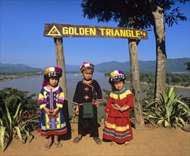 Hilltribe children before sign 'Golden Triangle'