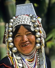 Akha woman with traditional clothing and headdress with silver bells