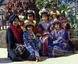 A group of children from the Lisu hill tribe wearing traditional costumes and headdresses