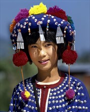 Lisu girl wearing a colourful headdress and the traditional costume of the mountain people