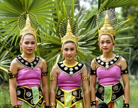 Three young women wearing traditional costumes