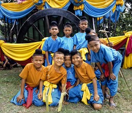 Group of boys wearing simple traditional clothing during a Loy Krathong parade