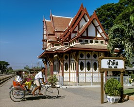 Royal Pavilion at Hua Hin Railway Station with a rickshaw driver