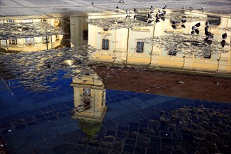 Catholic Garrison Church reflected in play of water at the Grand Square