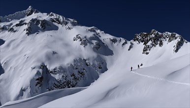 Mountain peak with ski mountaineers