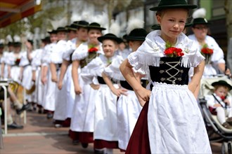 Children wearing traditional costume in a parade
