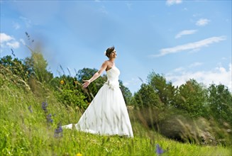 Bride standing on a meadow in Tyrol