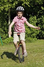 Girl riding a unicycle