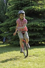 Girl riding a unicycle