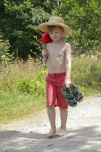 Boy with stick and hat