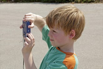 Young boy taking pictures