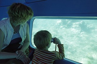 Woman and boy travelling in a semi submersible boat