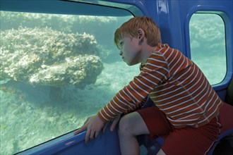 Boy travelling in a semi submersible boat