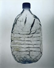 Flattened plastic water bottle