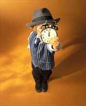 Boy wearing business clothes holding an alarm clock showing eleven fifty-five