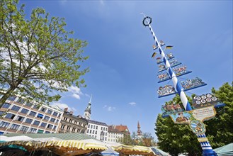 Viktualienmarkt square with a maypole and the colourful umbrellas of the market stalls