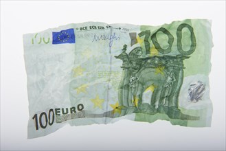 A crumpled 100 euro banknote