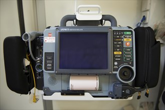 Portable electrocardiogram with a defibrillator in an ambulance