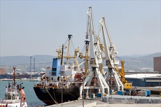 Cargo ship being unloaded in the port of Koper