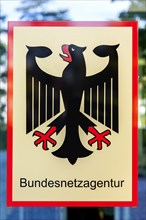 Sign with federal eagle on the headquarters of the Bundesnetzagentur or Federal Network Agency