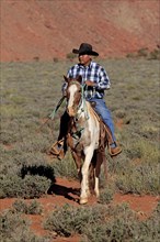 Navajo cowboy riding on a Mustang