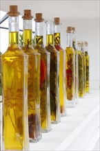 Bottles with olive oil and herbs