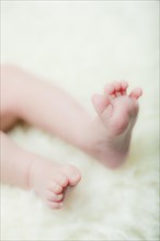 Feet of a baby on a sheepskin rug