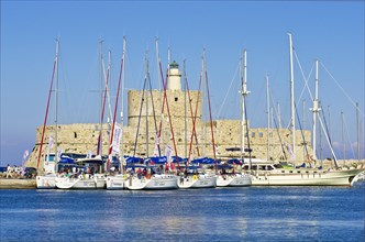 Sailing ships in front of the fortified tower of Agios Nikolaos