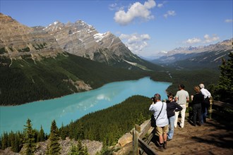Observation platform with tourists admiring Peyto Lake in the Rocky Mountains