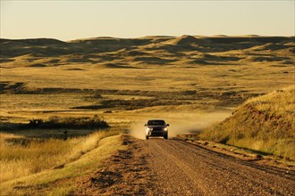Car on a dirt road on the prairie