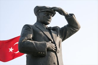 Mustafa Kemal Atatuerk statue next to the Turkish flag